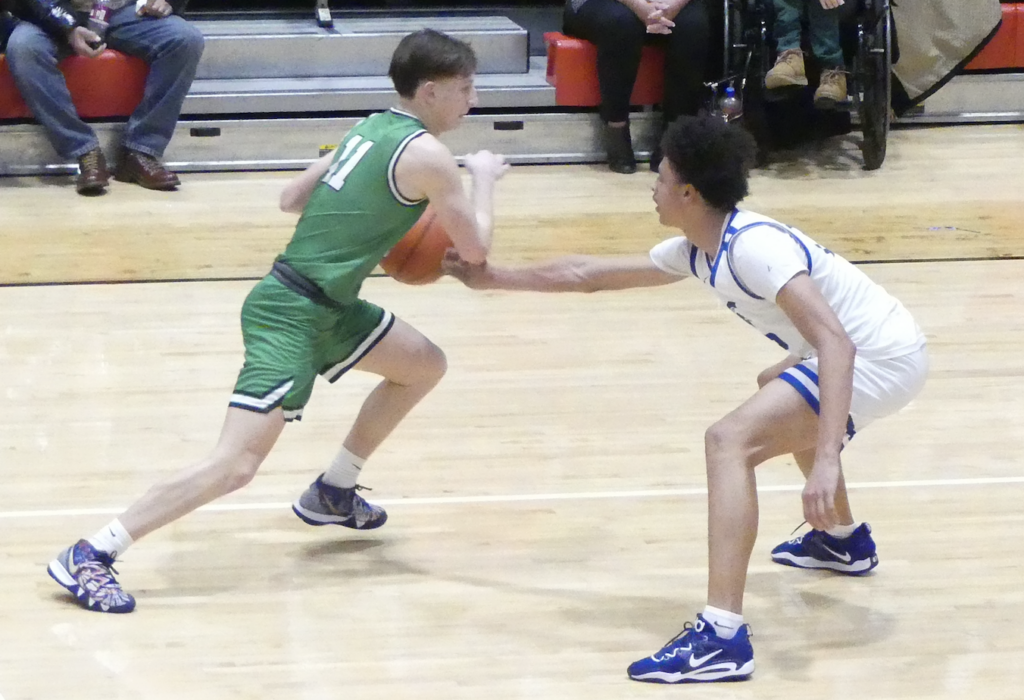 Mogadore's Nick Coffman dribbles against Richmond Heights' Hosea Steele. Tom Nader/Portage Sports